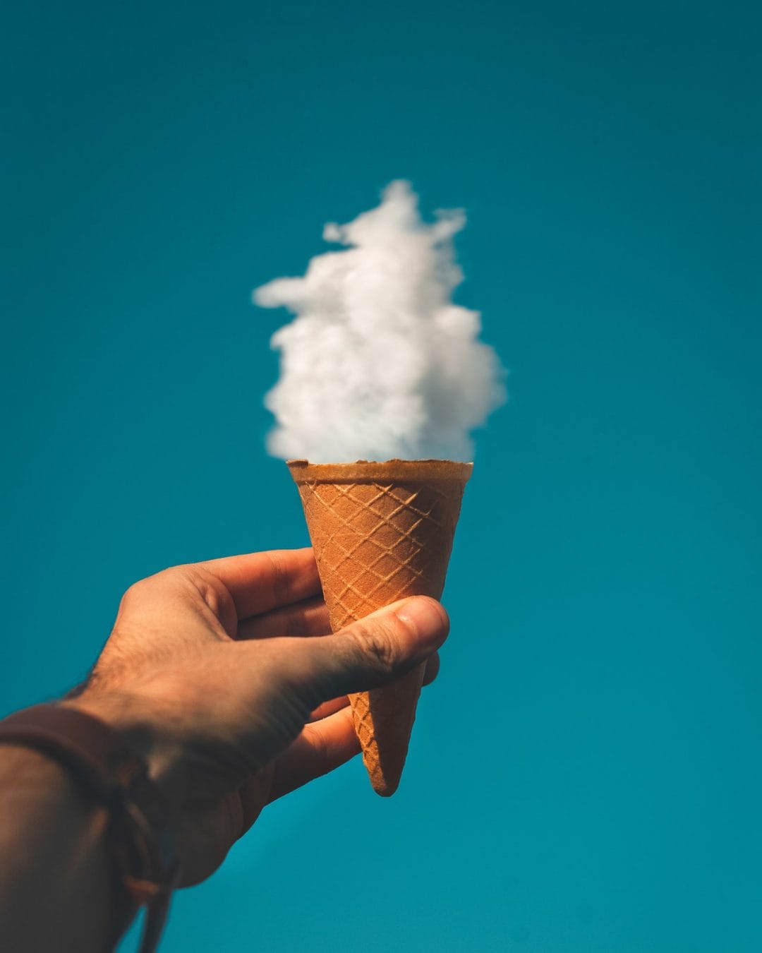 Man Holding Ice Cream Cone Under Cloud 1262302